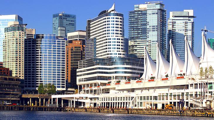 A harbor in front of skyscrapers under a sunny blue sky