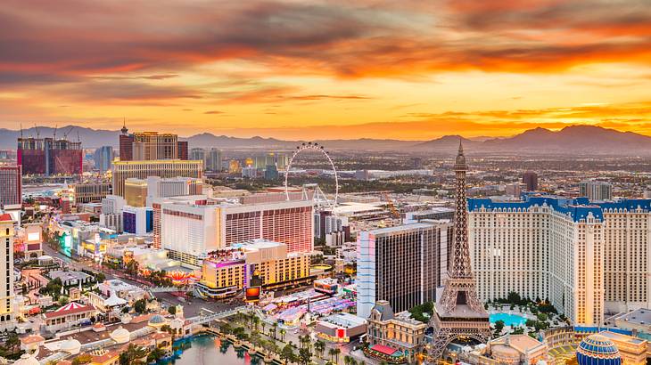 Aerial view of a city at sunset with many buildings and Las Vegas landmarks