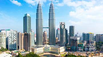City skyline with tall buildings and a park with a body of water in front City skyline with tall buildings and a park with a body of water in front