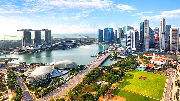 Tall buildings in Singapore's Financial District facing a park and a body of water