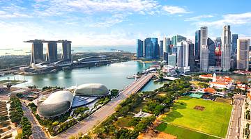 Tall buildings in Singapore's Financial District facing a park and a body of water