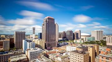 Sideview of a downtown area with modern buildings against a partly cloudy sky