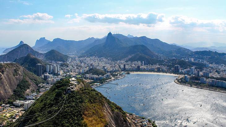 A landscape of Rio de Janeiro with the Christ the Redeemer statue in the foreground