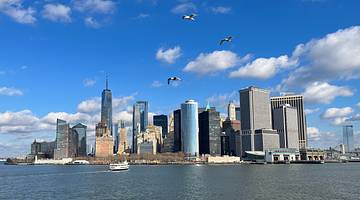 A city skyline with many buildings near a body of water