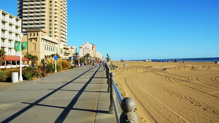 Buildings next boardwalk along a golden sandy beach