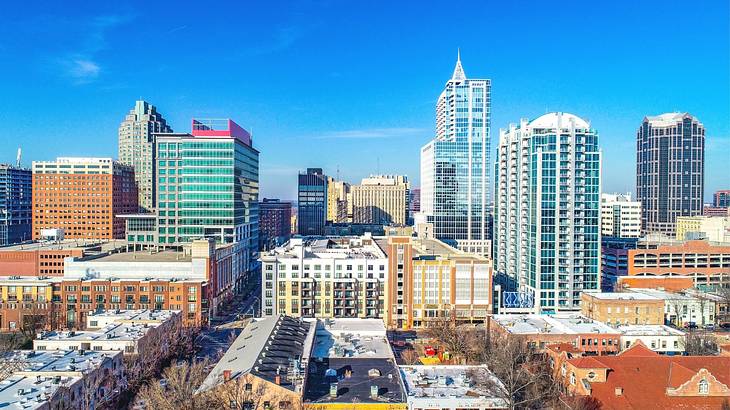 A city skyline with high rise buildings under a clear blue sky