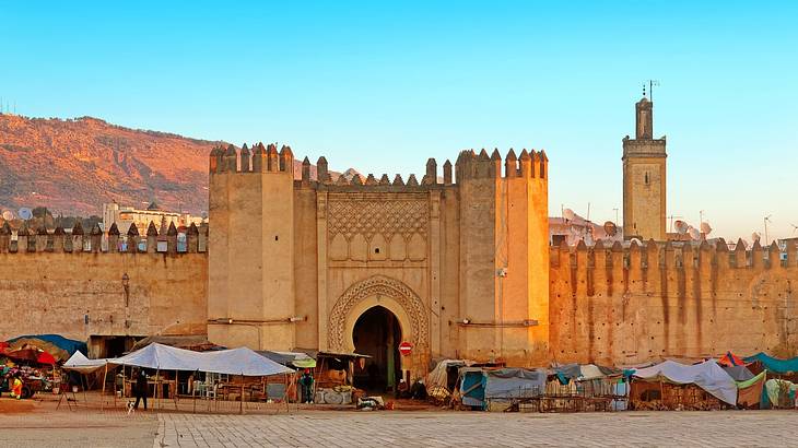 A Moroccan-style gate wall with stalls in front