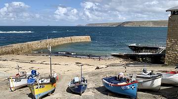 Boats docked in Sennen Cove, a must on your Cornwall road trip