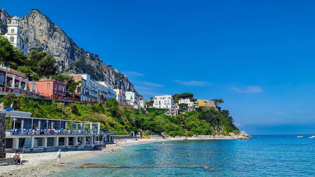 An island with a mountain and buildings on a sunny day