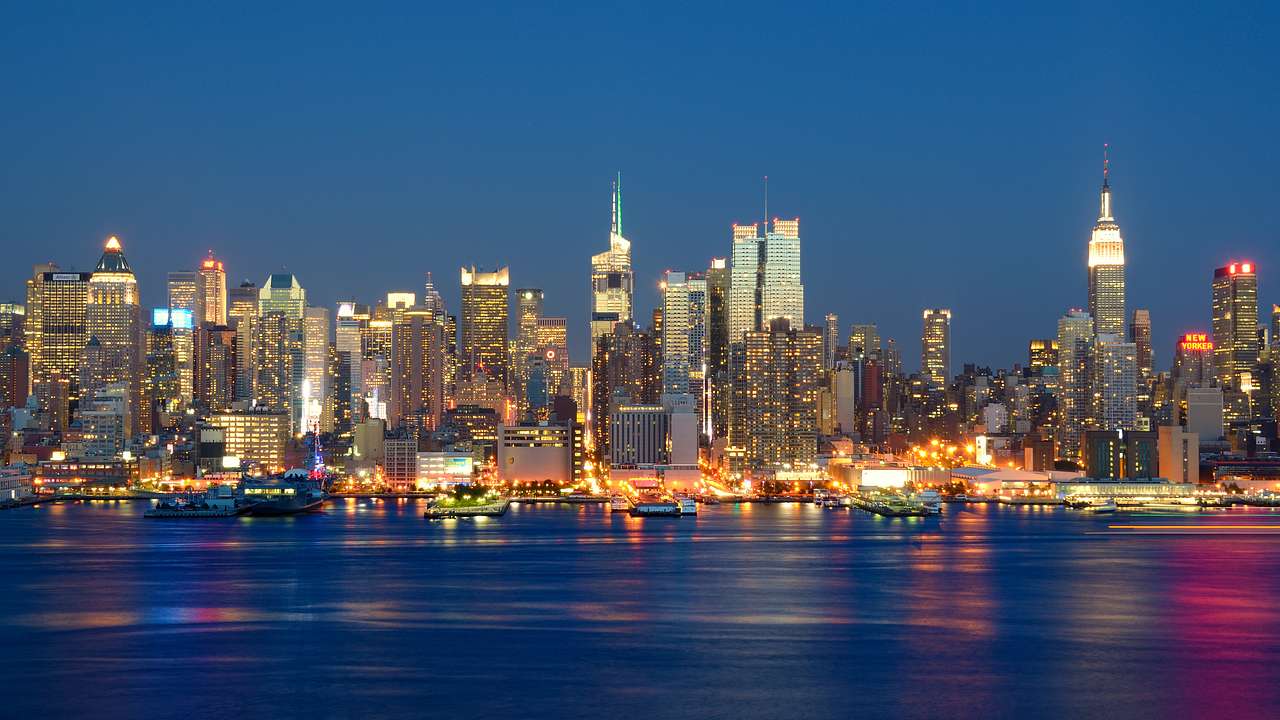The Manhattan skyline at night with water in front