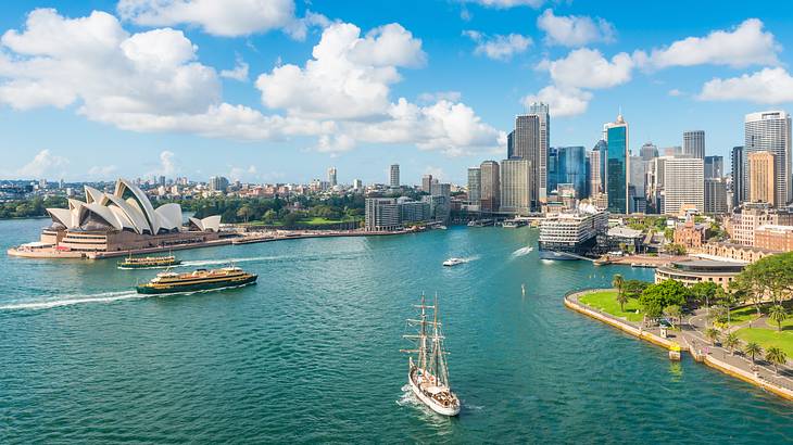 A body of water with ships near a highly-urbanized area