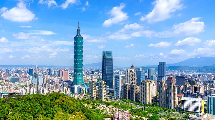 Taipei skyline full of tall buildings and a skyscraper on a sunny day