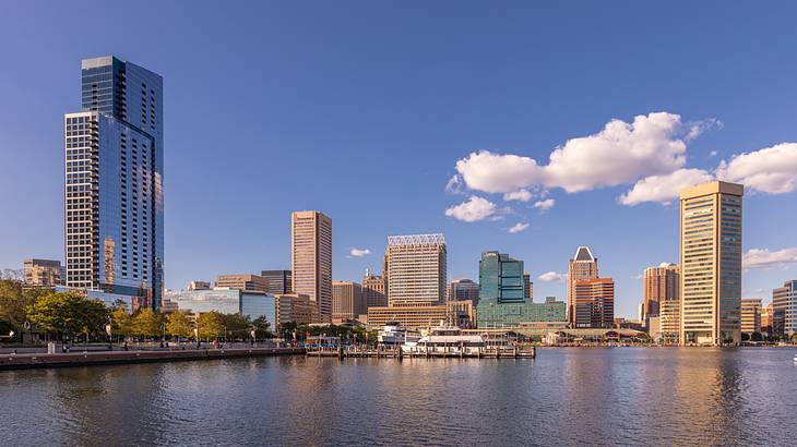 Tall skyscrapers with a body of water in the foreground