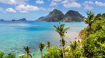 Stunning scenic view of blue water, palm trees and mountain islands, Palawan