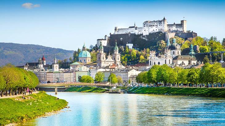 Castles and buildings on a mountain near a river