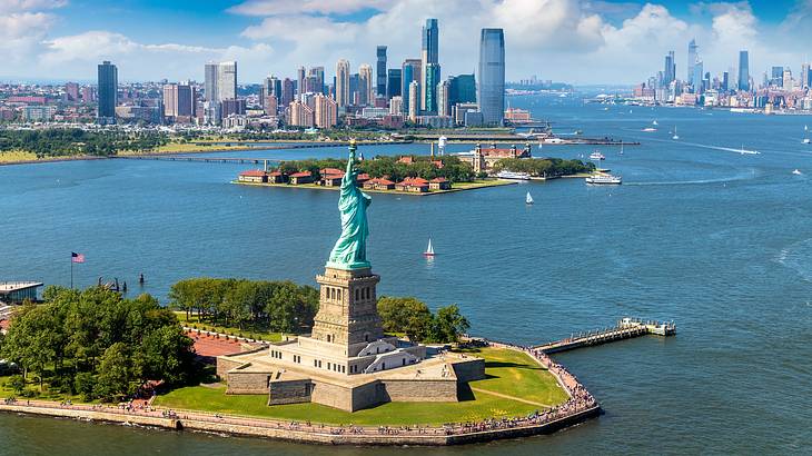 An islet with a statue near other islets with buildings and skyscrapers