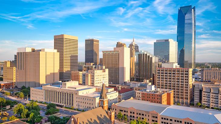 A city skyline under a blue sky with light clouds