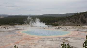 Things to do in Wyoming - Smokey white clouds rising from a hot spring in ground