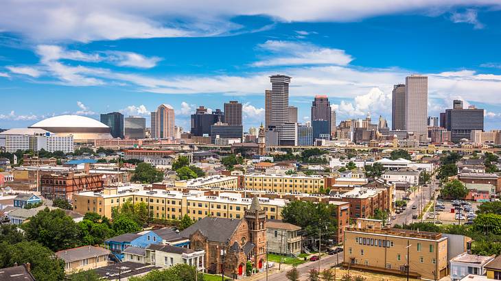 The New Orleans skyline with skyscrapers and buildings under a blue sky