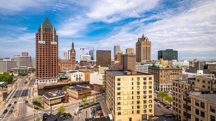 An aerial shot of an urban city under a sunny blue sky