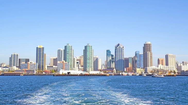 A city skyline with water in front of it on a clear day