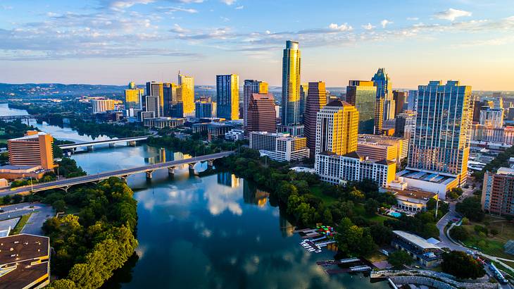 A city with a river running through it and large buildings in the background