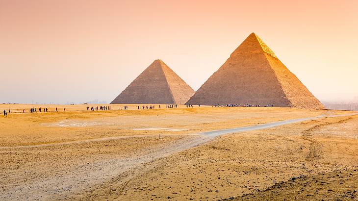 The sun setting behind the Pyramids of Giza, iconic Egypt landmarks
