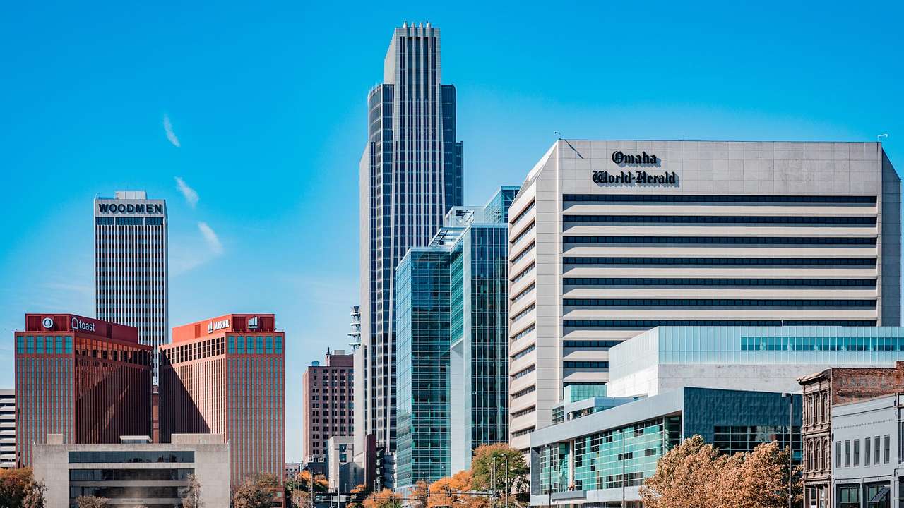 City skyscrapers and a building with an "Omaha World-Herald" sign on a bright day