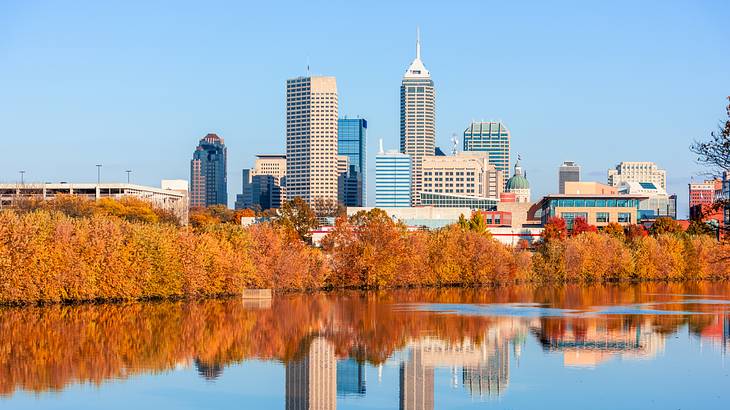 A body of water near tall skyscrapers and buildings on a sunny day