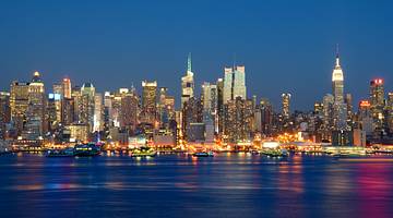 The Manhattan skyline at night with water in front