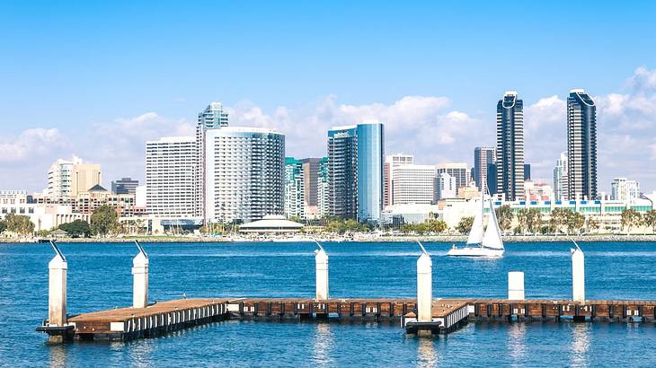 A skyline with water and an empty boat dock in front of it