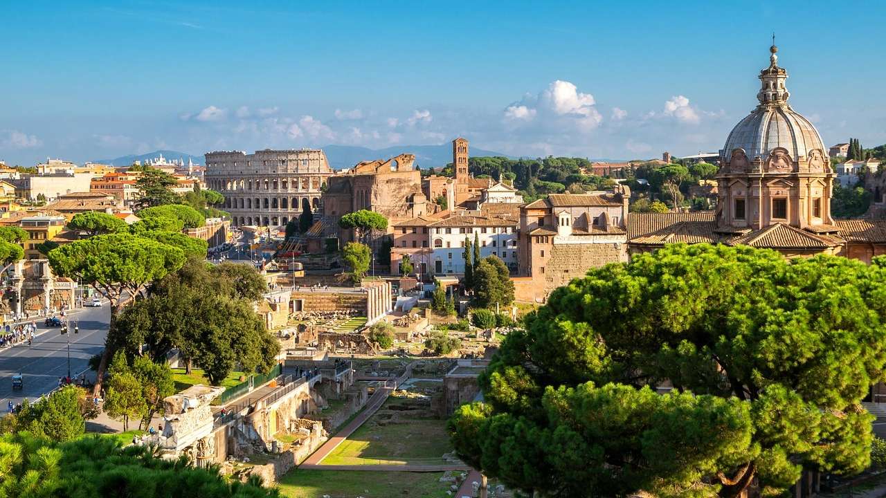 A view across Rome with the Colosseum, other Italian buildings, and trees
