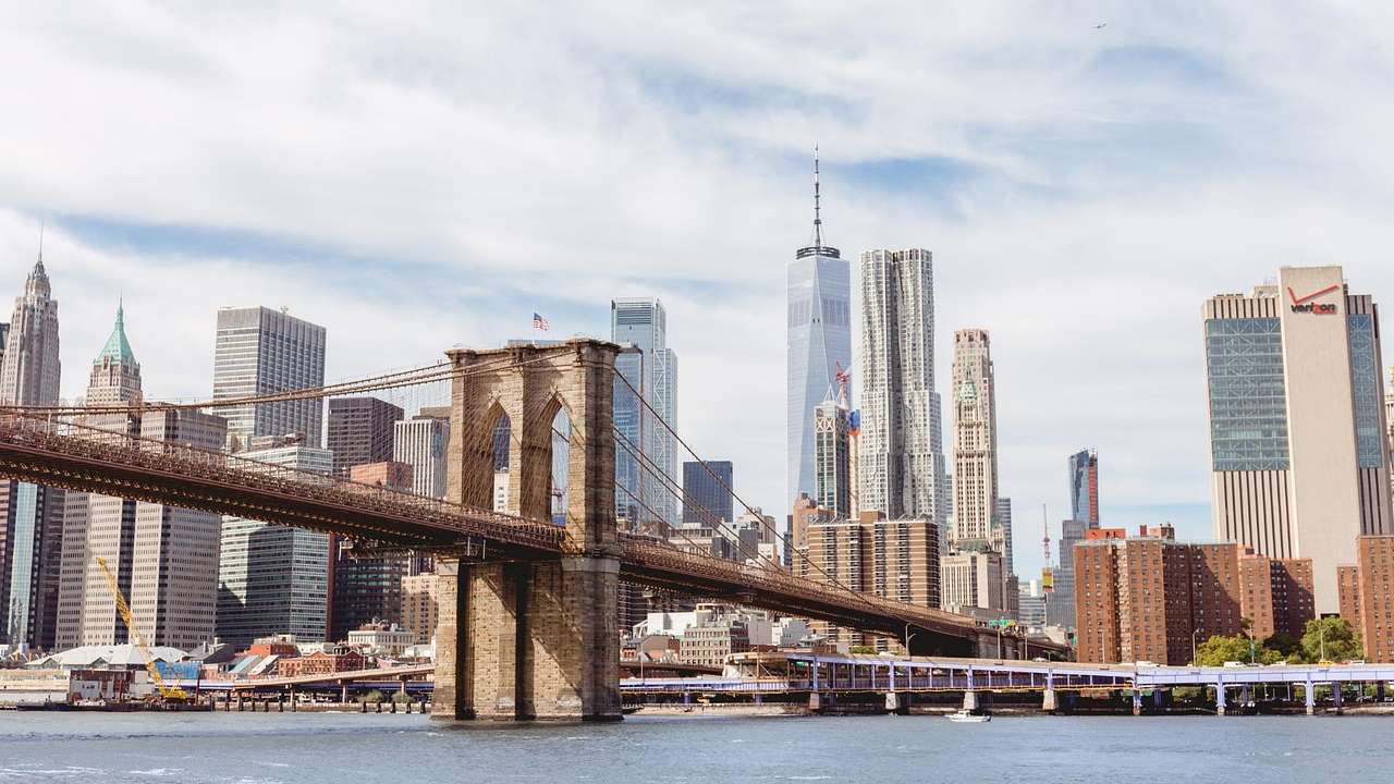 The Manhattan Skyline with skyscrapers, a river, and the Brooklyn Bridge