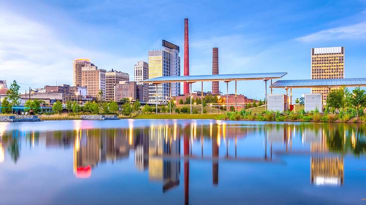 A lake with a skyline next to it that's reflected into the water