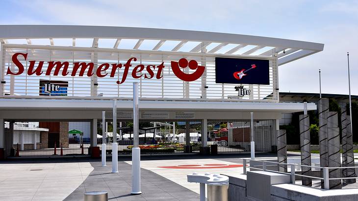 A sign reading "Summerfest" mounted on top of the entrance of an outdoor event venue