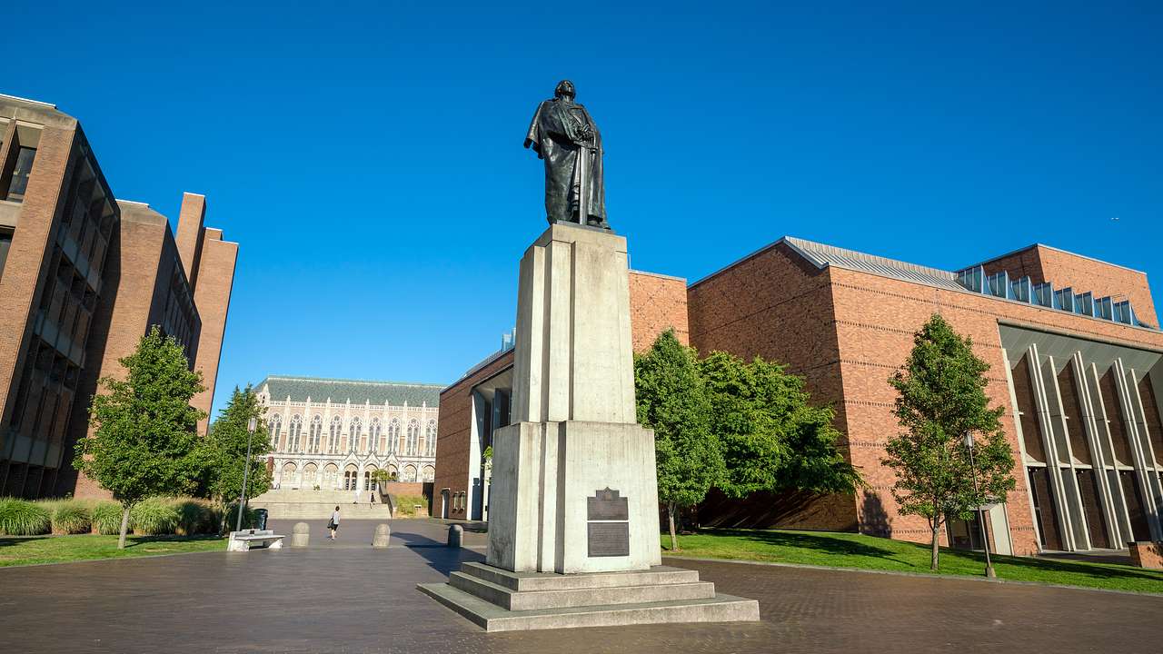 A monument with a bronze sculpture of a man on top in the middle of an open space