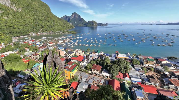 A coastal town from above surrounded by boats and mountainous islands, Palawan