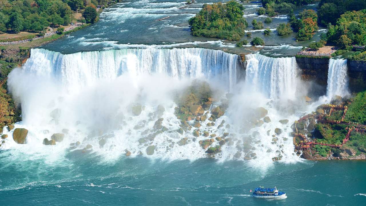 The powerful Niagara Falls from above with a boat on bottom right, Ontario, Canada
