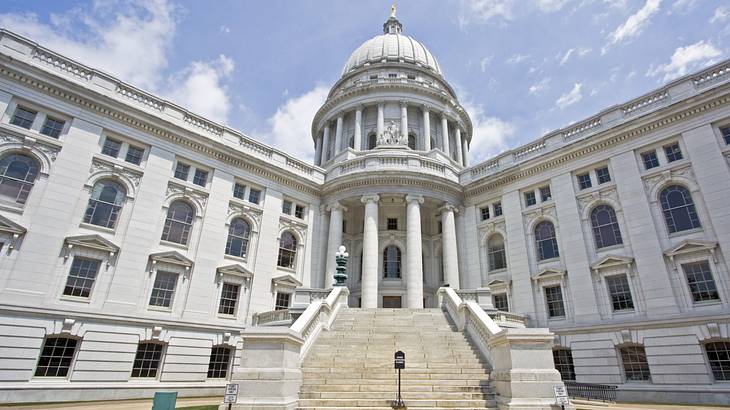 Large stone stairwell leading to the entrance of a white building with a dome Large stone stairwell leading to the entrance of a white building with a dome