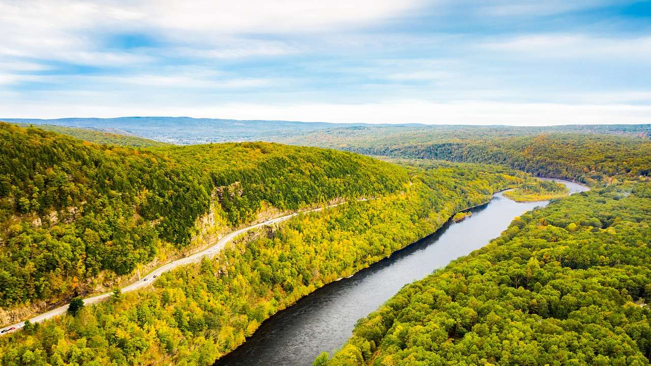 An aerial view of the Delaware River with green trees surrounding it