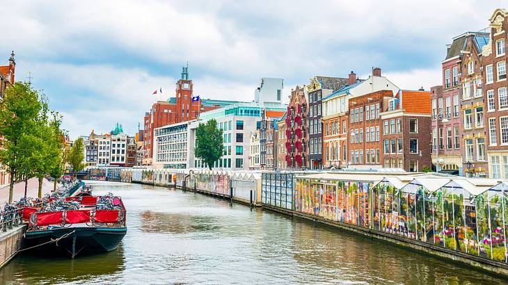 A canal with a boat on it next to colourful buildings