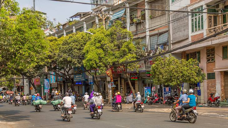 People on bikes on a street in HCMC, Vietnam