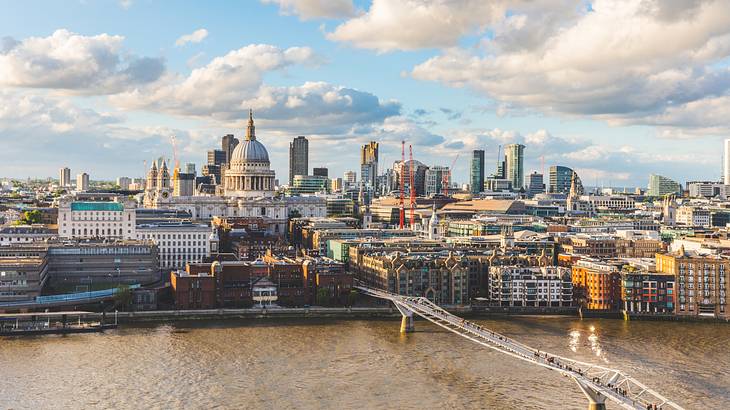 Aerial view of a city with buildings, a cathedral and a bridge over water, London, UK