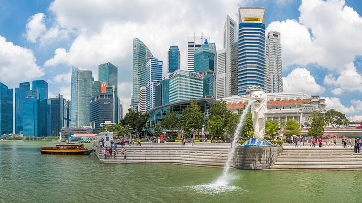 Singapore's Merlion Statue spouting water from its mouth back into the water