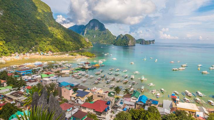 A coastal town from above surrounded by boats and mountainous islands, Palawan