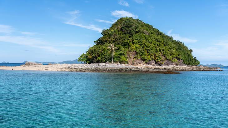 Beautiful lush green island surrounded by blue water, Palawan, Philippines Beautiful lush green island surrounded by blue water, Palawan, Philippines