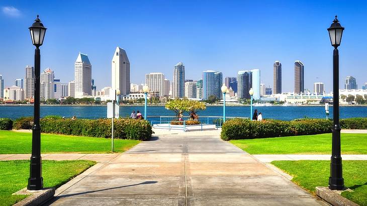 A skyline as seen from a park with the ocean in between