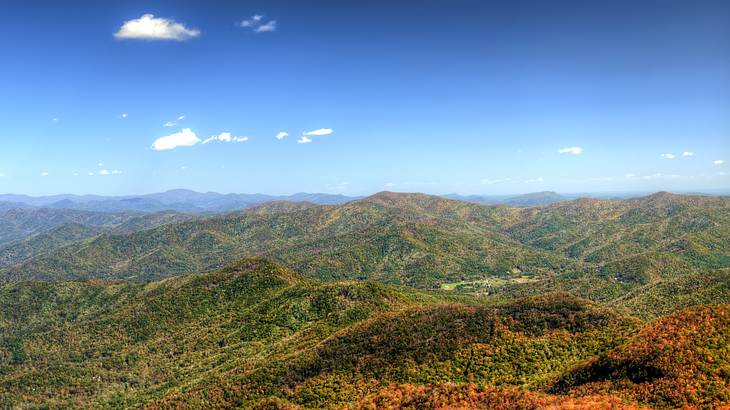Aerial view of mountains in hues of green and orange on a foggy morning Aerial view of mountains in hues of green and orange on a foggy morning