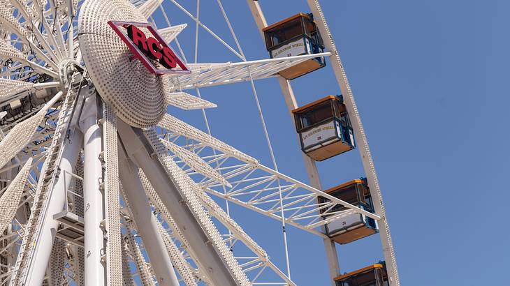 A Ferris wheel with a blue sky behind it
