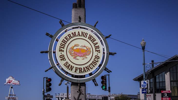 A ship's wheel sign that says "Fisherman's Wharf of San Francisco"